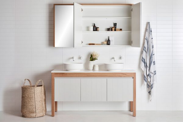 Bathroom mirror cabinet | Open above a freestanding bathroom vanity in a coastal bathroom setting.