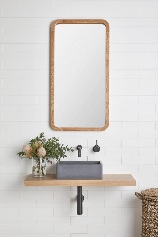 Timber frame mirror over a single floating timber shelf vanity