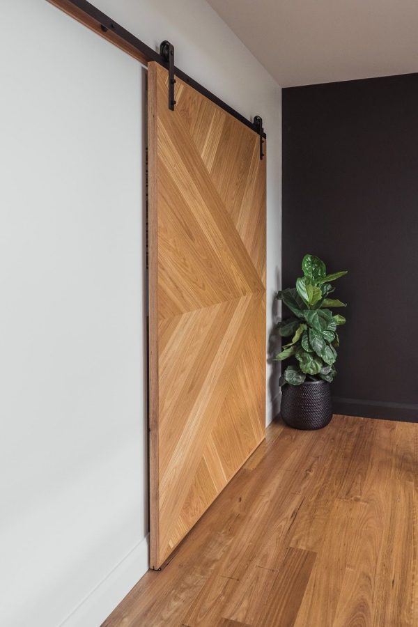 Interior Timber doors | two barn doors with black hardware shown from the side.