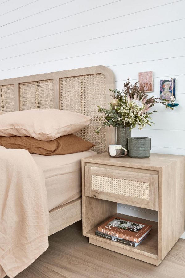 Rattan bed head styled in a coastal design bedroom.