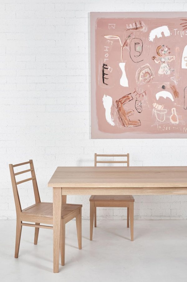 Two timber dining chairs with a timber dining table