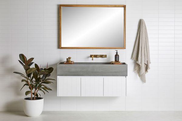 Timber frame mirror and wall hung timber vanity in a coastal style bathroom
