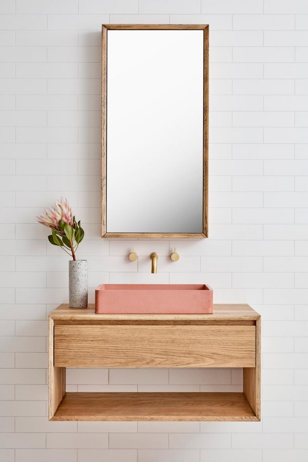 A mirrored bathroom cabinet hung over a single timber wall hung vanity