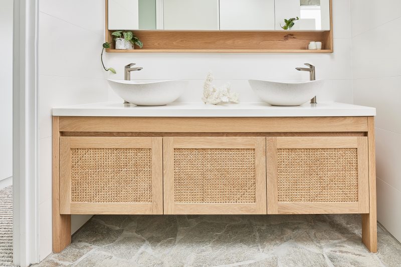 Freo Curved Vanity with Open Weave Rattan door profile + Elanora Mirror Cabinet. Both products in American Oak Light timber