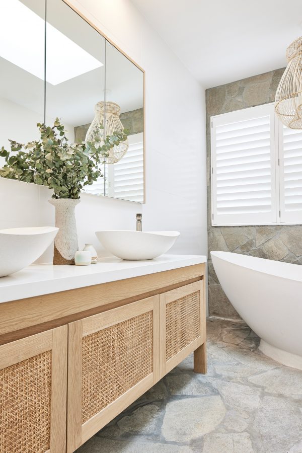 A coastal 3 door real timber Rattan vanity and White stone table top. With 2 white basins and silver tap ware | Loughlin Furniture