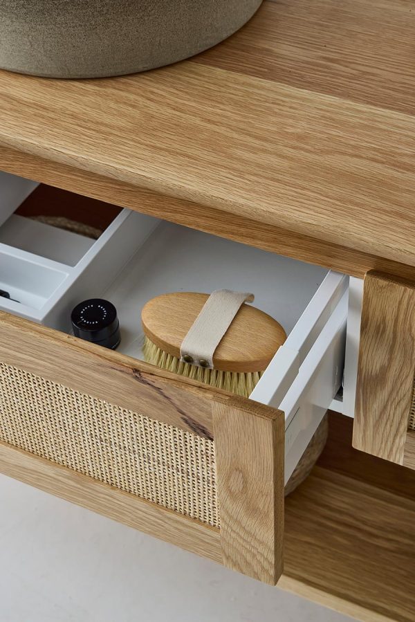 An open drawer of the custom made timber vanity | Pacific Baxter Vanity | The drawer profile features a tight weave rattan.
