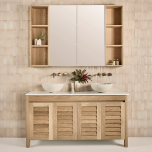 Freestanding timber vanity - frenchy - with louvre door panels in a bathroom setting underneath a mirrored bathroom cabinet